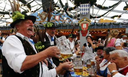 Revellers Salute With Beer After The Opening Of The 179th Oktoberfest In Munich