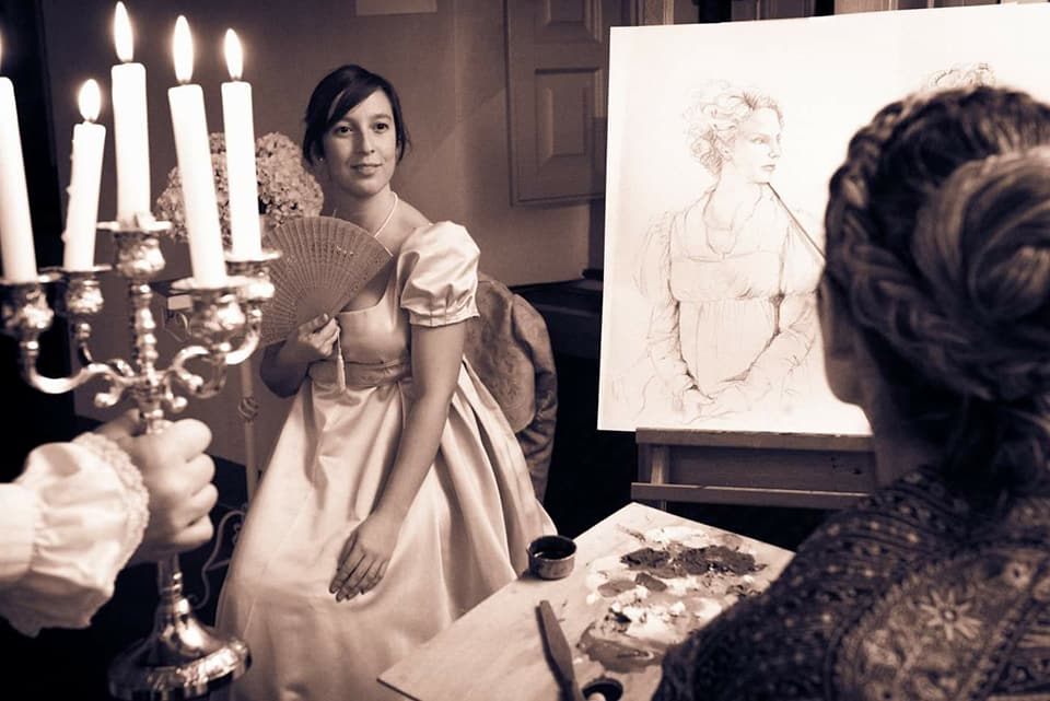 donna in posa davanti a un pittore che la ritrae in costume storico Club Jane Austen Sardegna