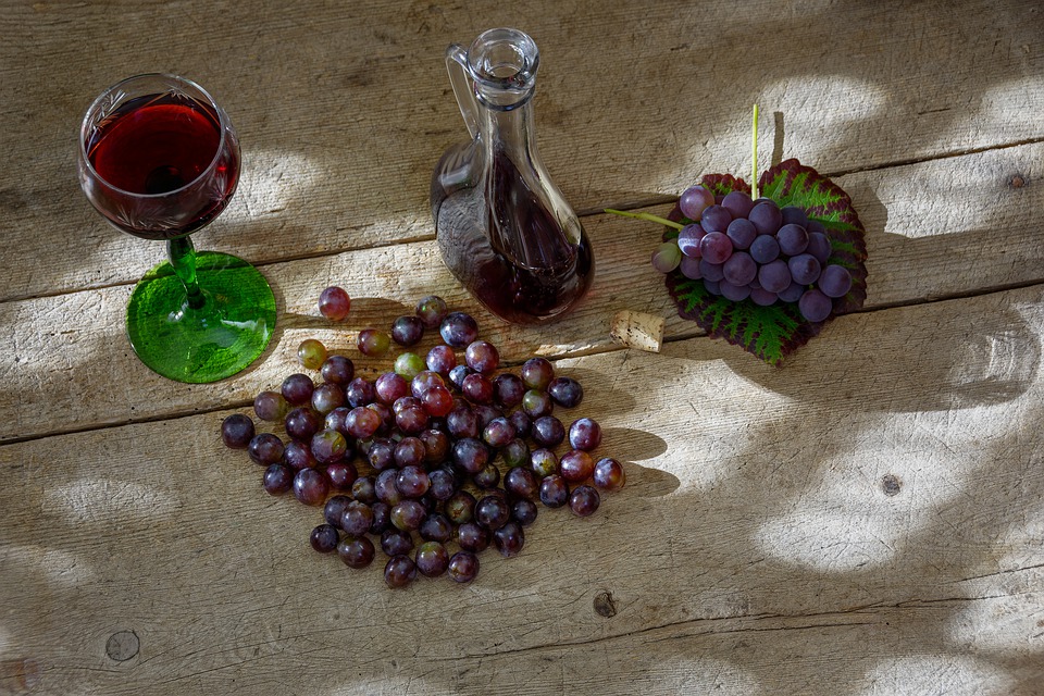 Vino Nuovo con i grappoli di uva su un tavolo