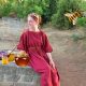 Giornata mondiale delle api - Venditrice Di Miele Seduta con abito rosso