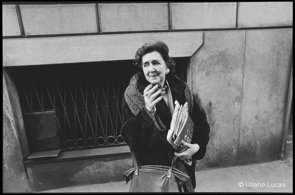foto in bianco e nero di Alda Merini che fuma una sigaretta in mezzo alla strada